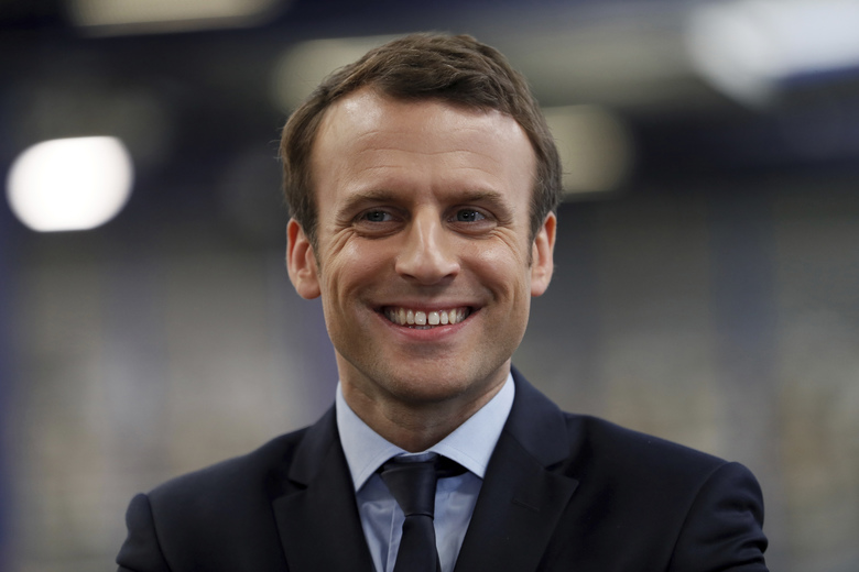 French presidential election candidate for the En Marche ! movement Emmanuel Macron reacts during his visit at the KRYS group’s headquarters in Bazainville near Paris Tuesday