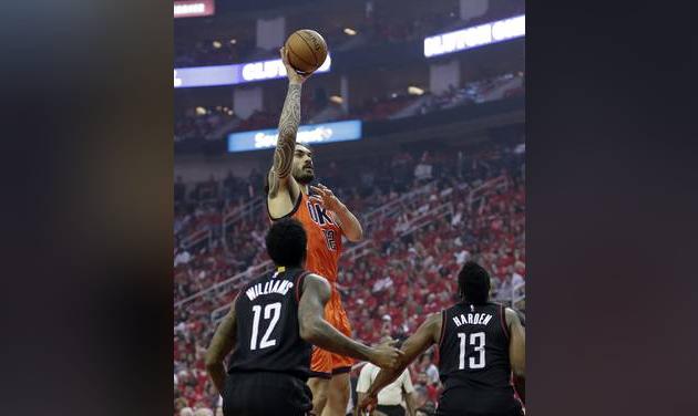 Oklahoma City Thunder's Steven Adams shoots against Houston Rockets&#039 Lou Williams and James Harden during the first half of Game 1 of an NBA basketball first-round playoff series Sunday