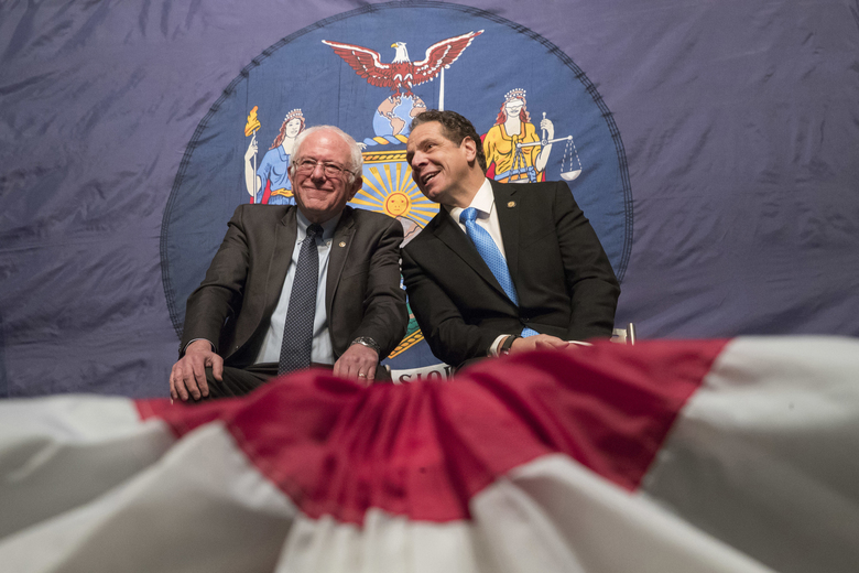 New York Gov. Andrew Cuomo right and Vermont Sen. Bernie Sanders appear onstage together during an event at New York’s La Guardia Community College. It’s the hope of proponents such as Sanders and Hillary Cl