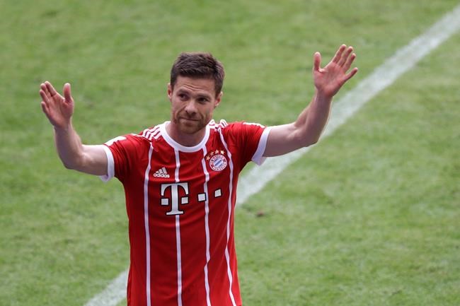 Bayern's Xabi Alonso waves to supporters as he leaves the field during the German first division Bundesliga soccer match between FC Bayern Munich and SC Freiburg at the Allianz Arena stadium in Munich Germany Saturday