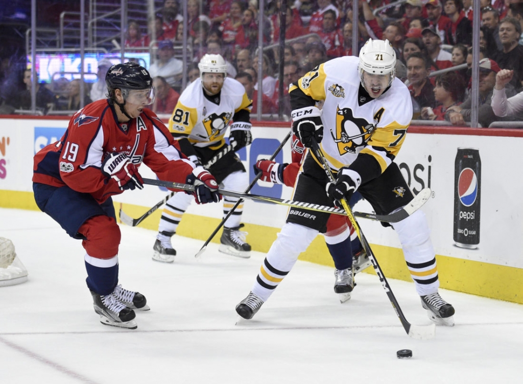 Pittsburgh Penguins center Evgeni Malkin, of Russia skates with the puck against Washington Capitals center Nicklas Backstrom, of Sweden during the first period in Game 1 of an NHL hockey Stanley Cup second-round playoff series Thursday Apri