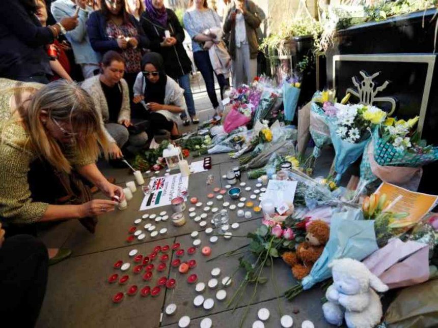 People take part in a vigil for the victims of an attack on concert goers at Manchester Arena in central Manchester Britain