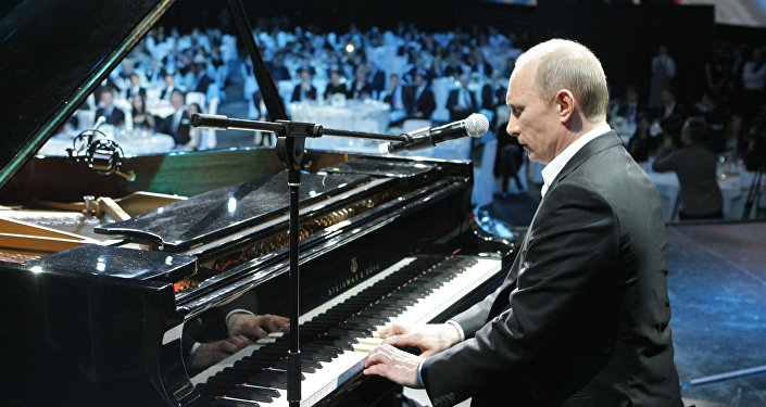 Russian President Vladimir Putin plays the piano at a charity concert for children stricken with cancer and eye diseases held at St. Petersburg's Ice Palace