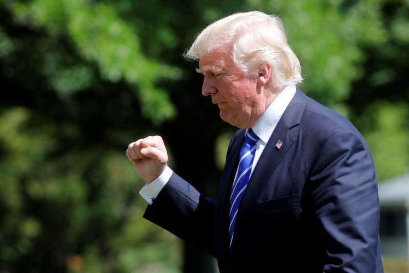 U.S. President Donald Trump gestures as he walks on the South Lawn of the White House upon his return to Washington U.S