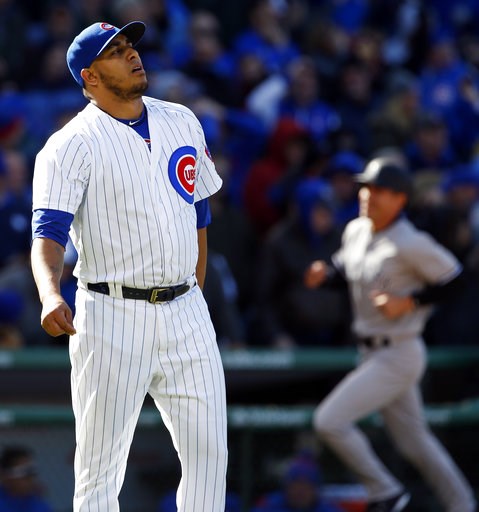 Chicago Cubs relief pitcher Hector Rondon left reacts as New York Yankees Brett Gardner right rounds the bases after hitting a three-run home run during the ninth inning of an interleague baseball game Friday