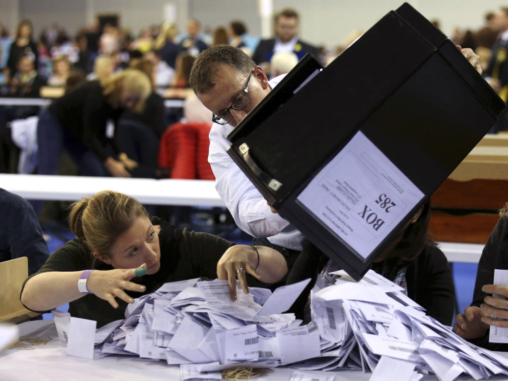 Ballot boxes are emptied to be counted for the general election in Glasgow Scotland