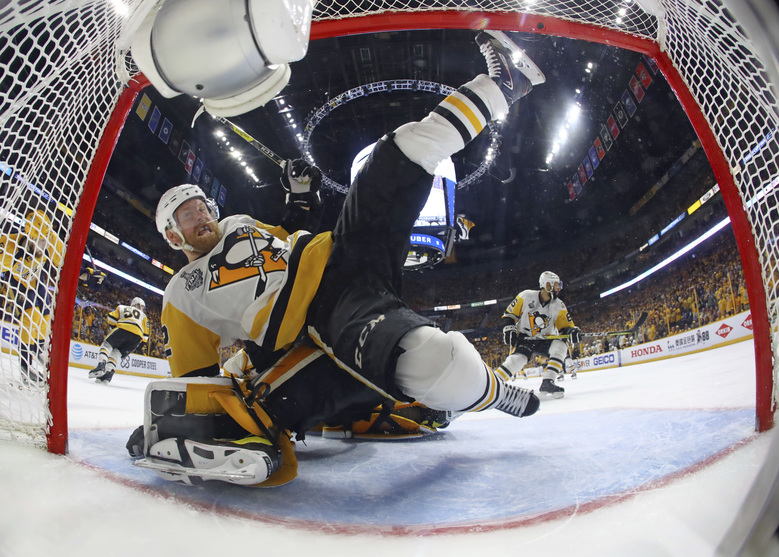 Pittsburgh Penguins defenseman Chad Ruhwedel falls over goalie Matt Murray during the periodagainst the Nashville Predators in Game 4 of the NHL hockey Stanley Cup Final Monday