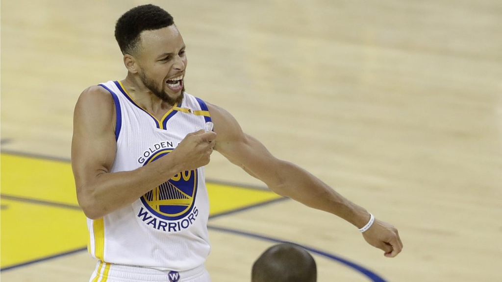 Warriors Stephen Curry reacts after scoring against the Cavaliers during Game 2 of basketballs NBA Finals in Oakland Calif. Sunday