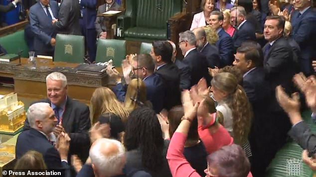 Labour leader Jeremy Corbyn is applauded by his MPs as he enters the House of Commons