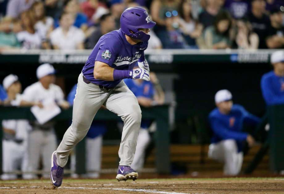 TCU's Austen Wade runs to first base where he was safe on a play at another base during the sixth inning of the team's NCAA College World Series baseball game against Florida in Omaha Neb. Friday