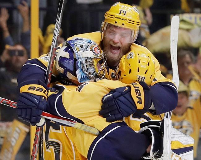 Nashville Predators defenseman Mattias Ekholm, of Sweden jumps on goalie Pekka Rinne, of Finland and left wing Viktor Arvidsson, of Sweden after the Predators beat the Anaheim Ducks to win Game 6 of the Western Conference final in the NH