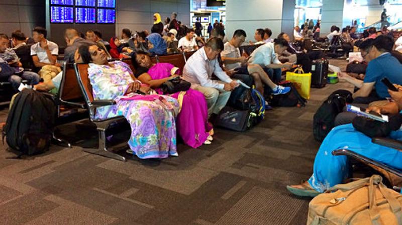 Passengers of cancelled flights wait in Hamad International Airport in Doha Qatar. Qatar's foreign minister says Kuwait is trying to mediate a diplomatic crisis in which Arab countries have cut diplomatic ties and moved to isolate his energy-r