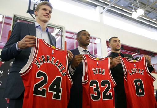 Chicago Bulls seventh overall draft pick Lauri Markkanen left Kris Dunn center and Zach Levine pose for