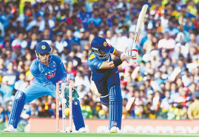 DAMBULLA Sri Lankan batsman Kusal Mendis is cleaned up by Indian spinner Axar Patel as wicket-keeper M.S. Dhoni looks on during the first One-day International at the Rangiri Dambulla International Cricket Stadium on Sunday.—AFP