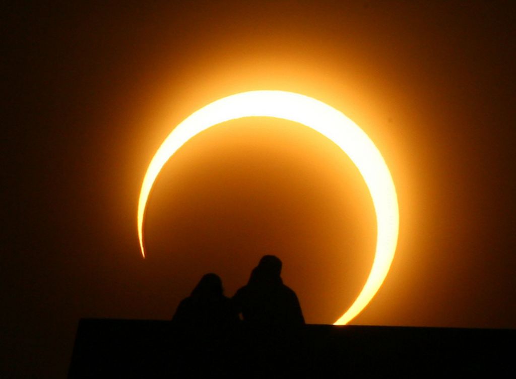 A Chinese couple watches a solar eclipse over Zhengzhou on Jan. 15 2010