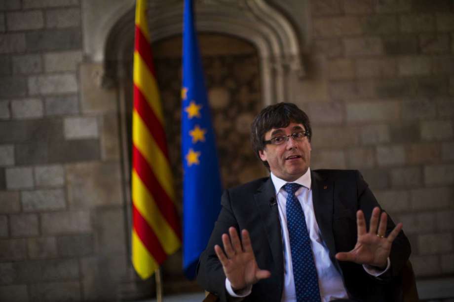 Catalonia's regional president Carles Puigdemont speaks during an interview with The Associated Press at the Palace of Generalitat or Catalan government headquarters in Barcelona Spain Wednesday Sept. 27 2017