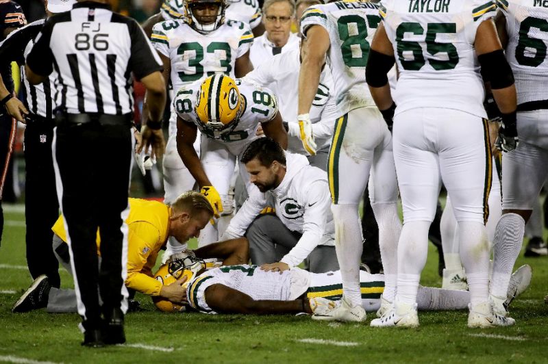 Davante Adams of the Green Bay Packers is attended to after being injured in the third quarter against the Chicago Bears