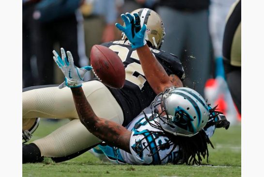 Carolina Panthers Kelvin Benjamin reaches for the ball as New Orleans Saints Kenny Vaccaro defends in the first half of an NFL football game in Charlotte N.C. Sunday Sept. 24 2017