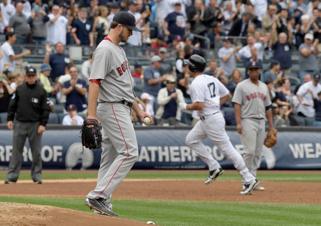 Boston Red Sox pitcher Drew Pomeranz left reacts as New York Yankees designated hitter Matt Holliday rounds the bases with a three-run home run