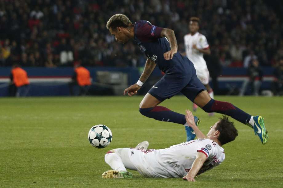 PSG's Neymar top is fouled by Bayern's Sebastian Rudy during the Champions League Group B soccer match between Paris Saint Germain and Bayern Munich in Paris France Wednesday Sept. 27 2017