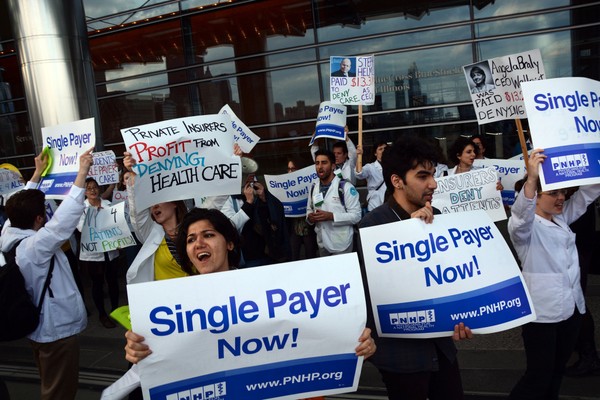 Members of the non-profit organization Physicians for a National Health Program rally in Chicago outside Blue Cross Blue Shield