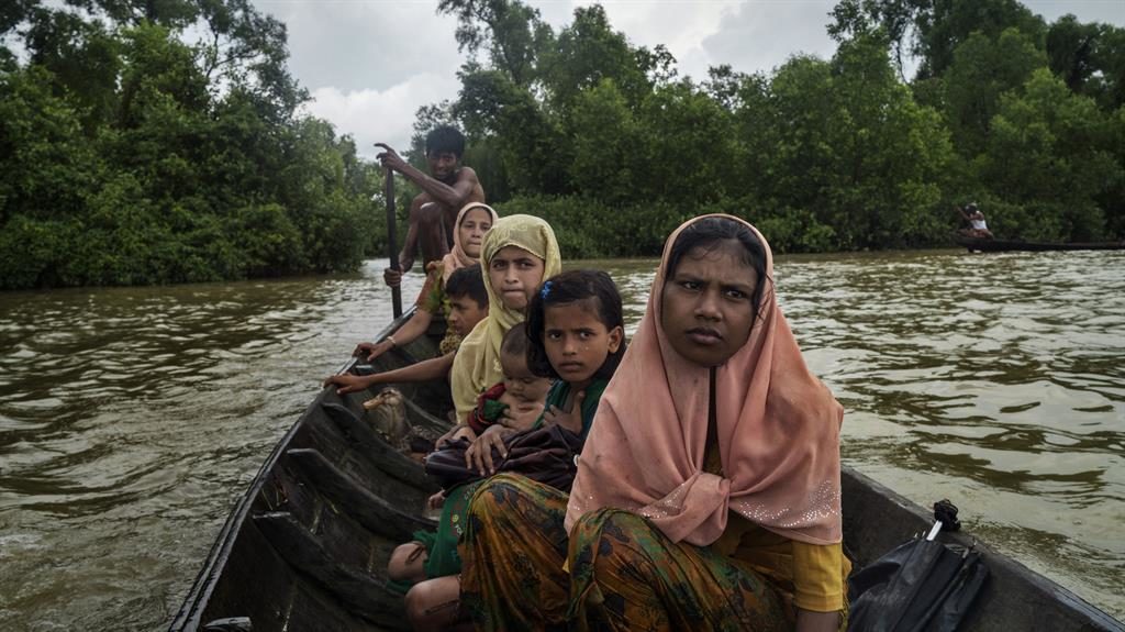 Safe harbour Tasmida 18 and other refugees escape their homeland in a boat across the border to Bangladesh