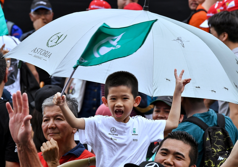 A young F1 fan cheers during the last Malaysian Formula One race at the Sepang International Circuit today. Bernama