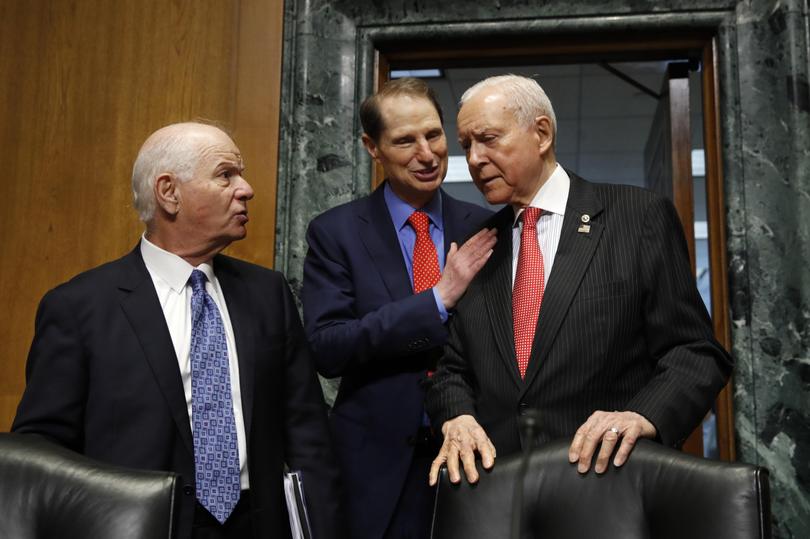 Sen. Ben Cardin D-Md. left talks with Ranking Member Sen. Ron Wyden D-Ore. and Senate Finance Committee Chairman Orrin Hatch R-Utah right at the start of a committee hearing on Thursday Sept. 14 2017 on Capitol Hill in Washington. On Wednesday