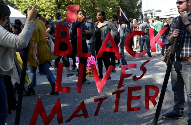 Demonstrators hold a'Black Lives Matter banner while participating during the March for Racial Justice in Brooklyn