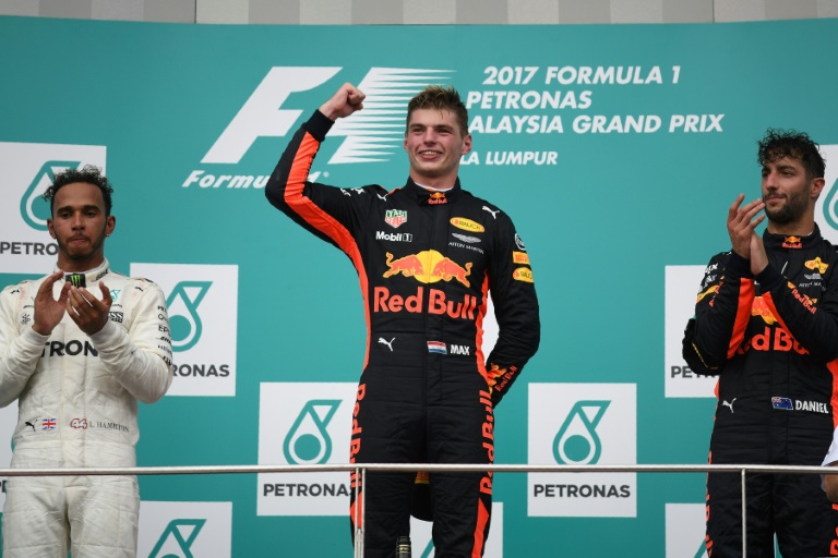 Red Bull's Dutch driver Max Verstappen celebrates on the podium after winning the Malaysian Formula One Grand Prix in Sepang