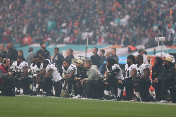 The New Orleans Saints kneel before the singing of the national anthem prior to their game against the Miami Dolphins at Wembley Stadium in London on Sunday Oct. 1 2017