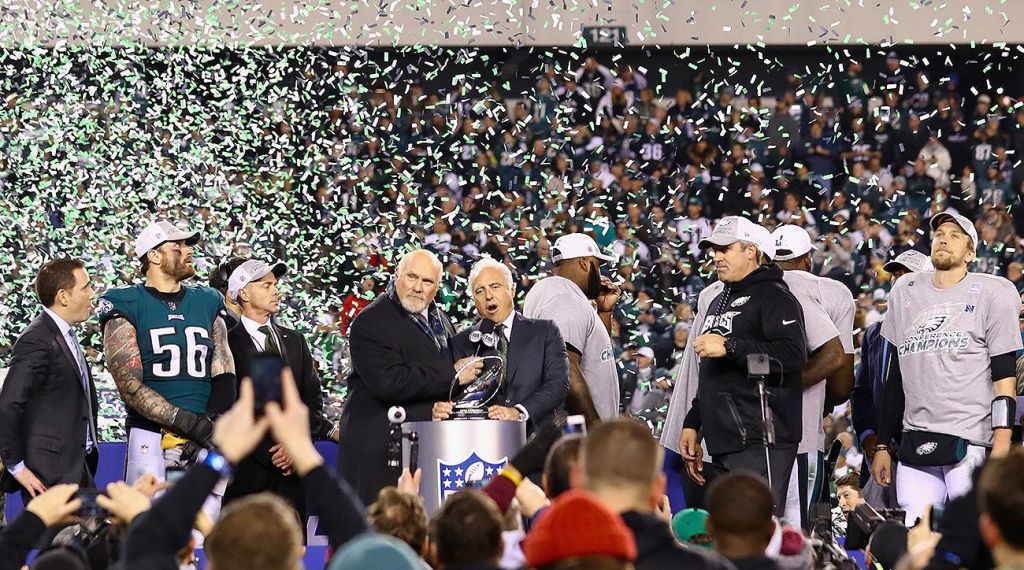 Eagles owner Jeffrey Lurie shows off the NFC Championship trophy. / Credit Sports Illustrated