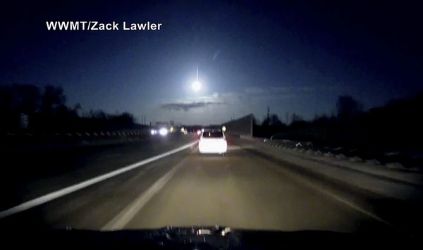 In this late Tuesday Jan. 16 2018 image made from dashcam video a brightly lit object falls from the sky above a highway in the southern Michigan skyline