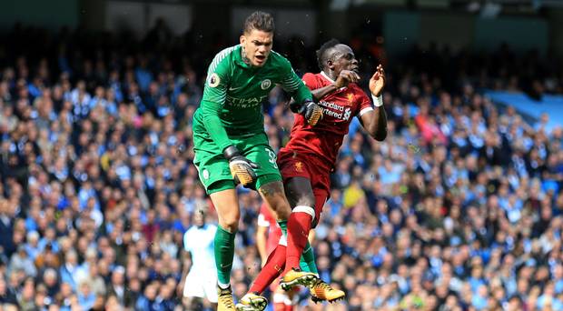 Sadio Mane collides with Manchester City goalkeeper Ederson earlier this season