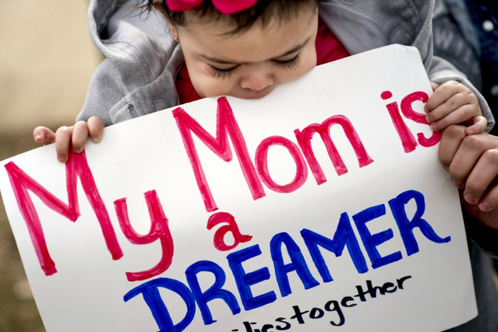 Yesenia Aguilar of Reading Pennsylvania holds her 1-year-old daughter Denalli Urdaneta at an immigration rally on Capitol Hill in Washington on Tuesday