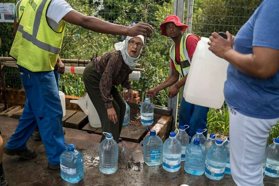 City residents collect water from a spring. A three-year drought is considered the worst in over a century