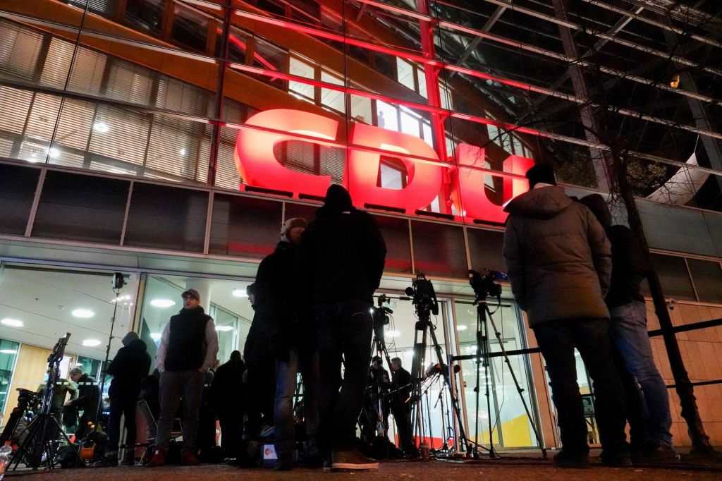 Journalists wait outside the Christian Democrats headquarters as negotiators from the German chancellor's party and the Social Democrats gather for to clinch an agreement. AFP  DPA  Kay Nietfeld