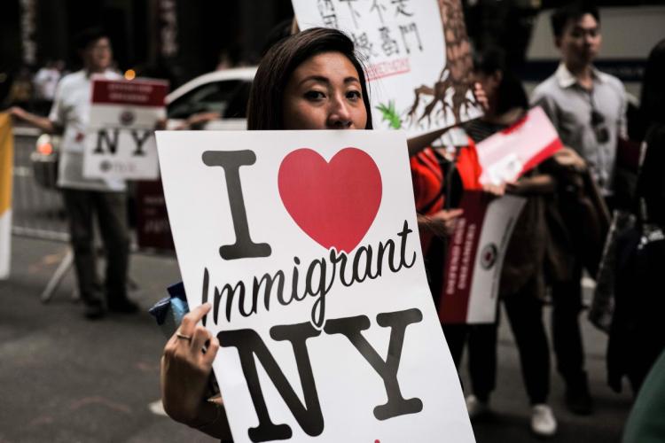 Protesters hold up signs during an October 2017 demonstration against President Trump during a rally in support of the Deferred Action for Childhood Arrivals near Trump Tower in New York