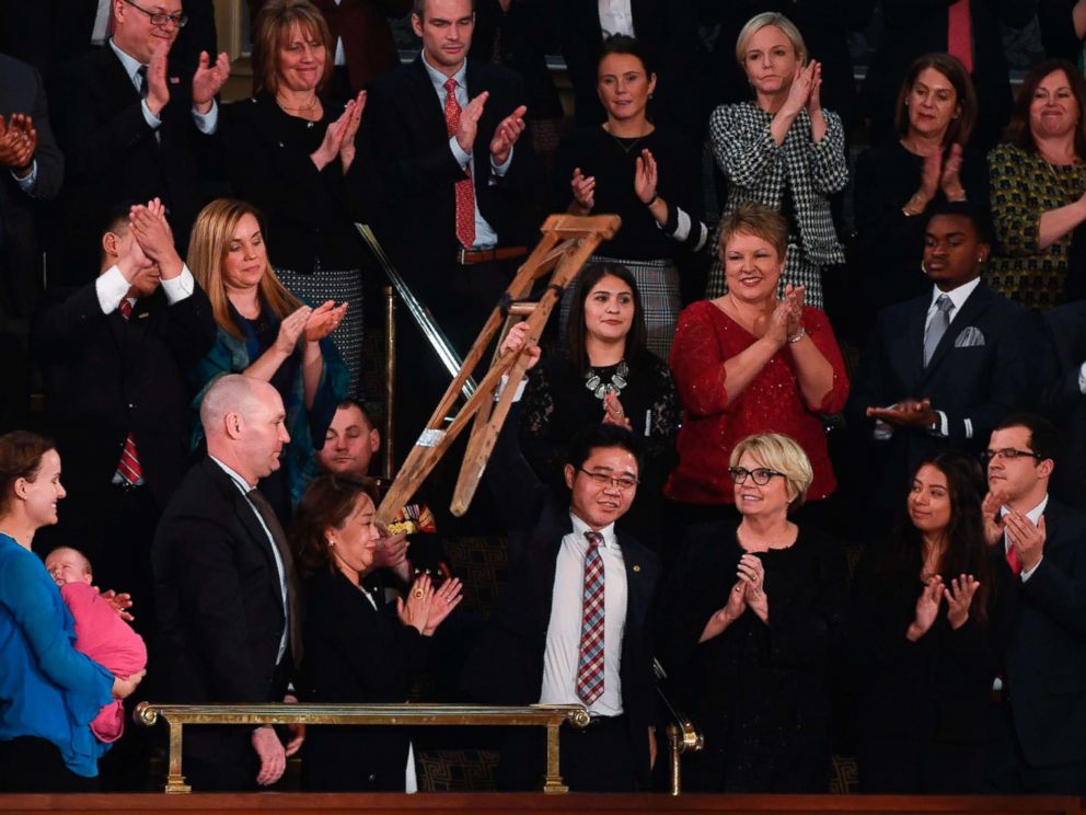 Ji Seong-ho raises his crutches as President Donald Trump delivers his State of the Union address at the US Capitol in Washington on Jan. 30 2018