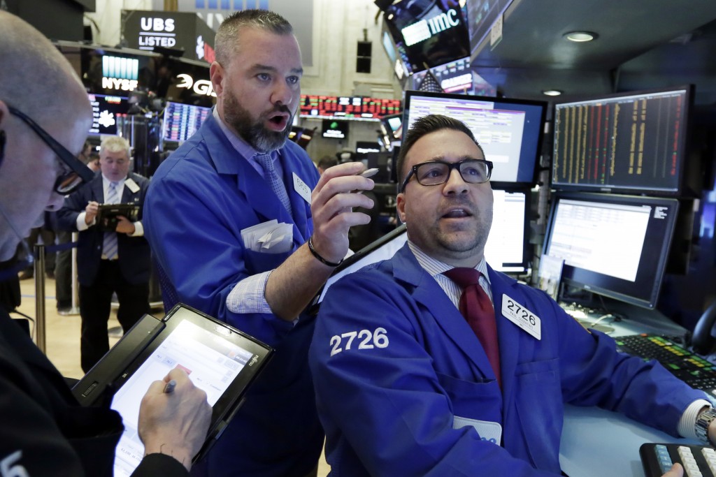 Trader Kevin Lodewick center and specialist Paul Cosentino right work on the floor of the New York Stock Exchange Tuesday Feb. 6 2018. The Dow