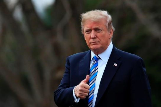 President Donald Trump flashes a thumbs up as he walks as he leaves the White House Friday Feb. 16 2018 in Washington for a trip to his private Mar-a Lago resort in Florida