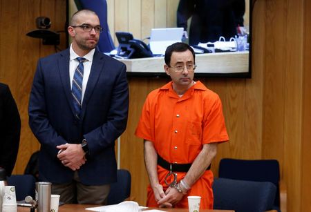 Larry Nassar a former team USA Gymnastics doctor who pleaded guilty to sexual assault and his attorney Newburg stand during victims impact statements during his sentencing in Charlotte