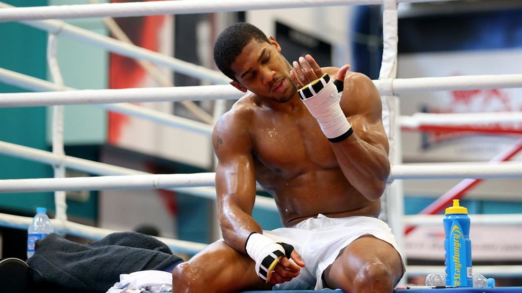 Tools of the trade Joshua takes a break during a workout in Sheffield yesterday