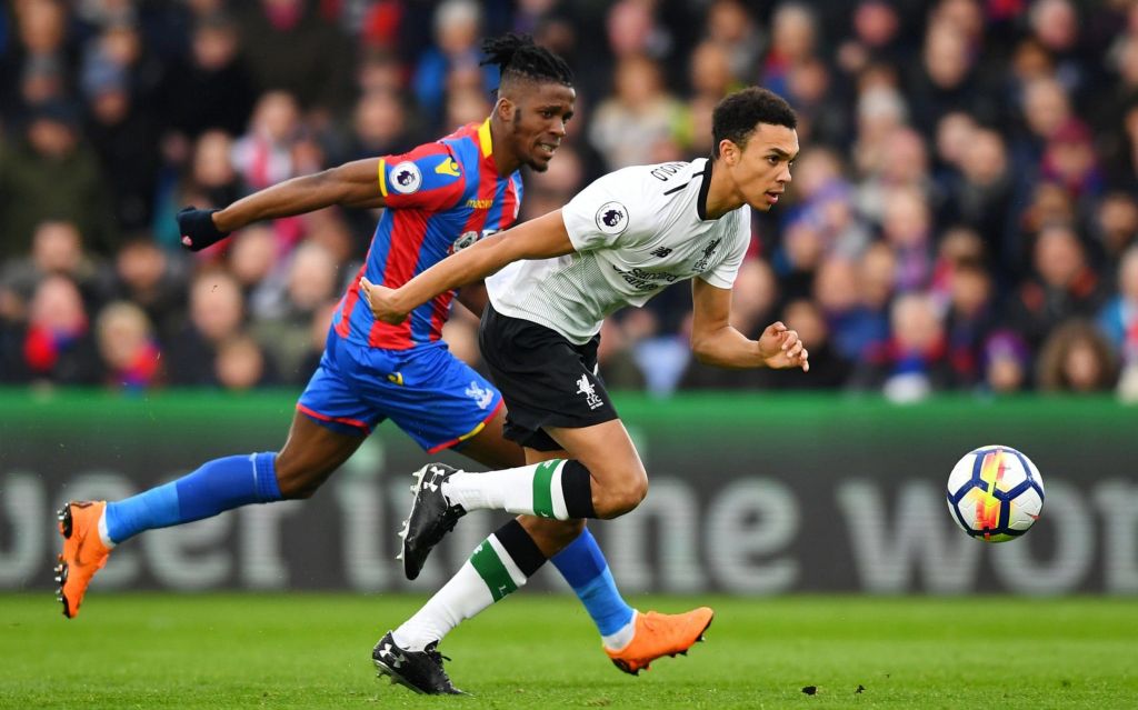 Crystal Palace's Wilfried Zaha harries Liverpool's Trent Alexander-Arnold