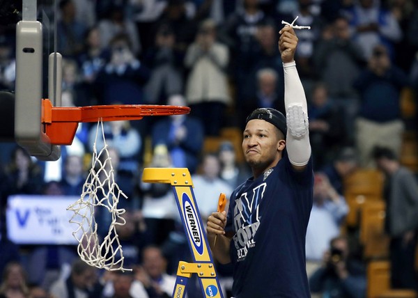 Villanova's Jalen Brunson celebrates after cutting a piece of net following the team's win over Texas Tech in an NCAA men's college basketball tournament regional final Sunday