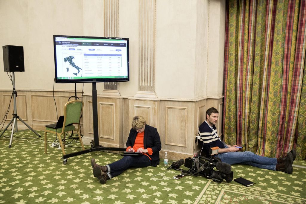 Members of the media wait for exit poll results and a news conference at Italy's anti-establishment Five Star Movement's electoral centre in Rome Italy on Monday