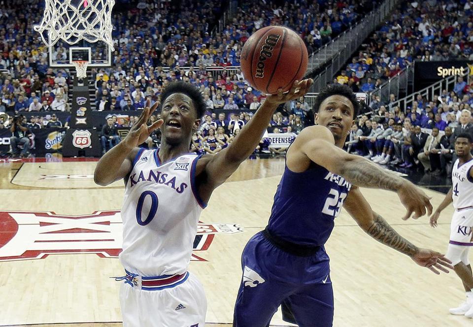 Kansas&apos Marcus Garrett gets past Kansas State's Amaad Wainright to put up a shot during the second half of an NCAA college basketball game in the semifinals of the Big 12 conference tournament in Kansas City Mo. Friday