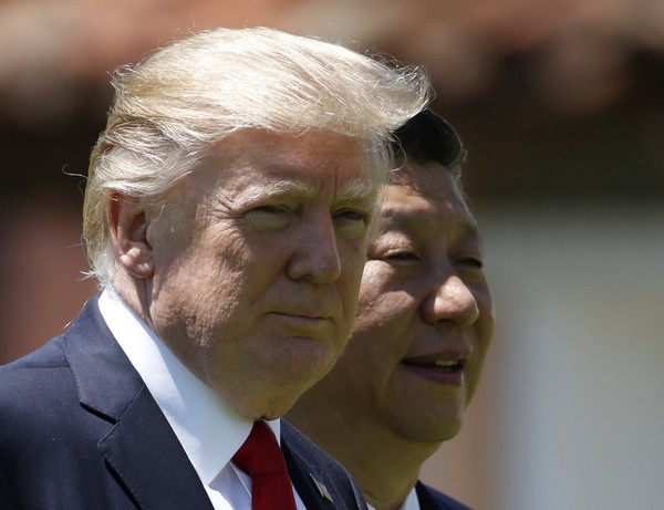 U.S. President Donald Trump left and Chinese President Xi Jinping walk together at Mar-a Lago in Palm Beach Fla. The U.S. is piling the pressure on Beijing to use its clout with North Korea to rein in its nucle