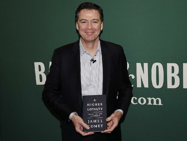 Credit AP  FRANK FRANKLIN II					Former FBI Director James Comey poses with his new book during an appearance Wednesday at a Barnes & Noble in New York