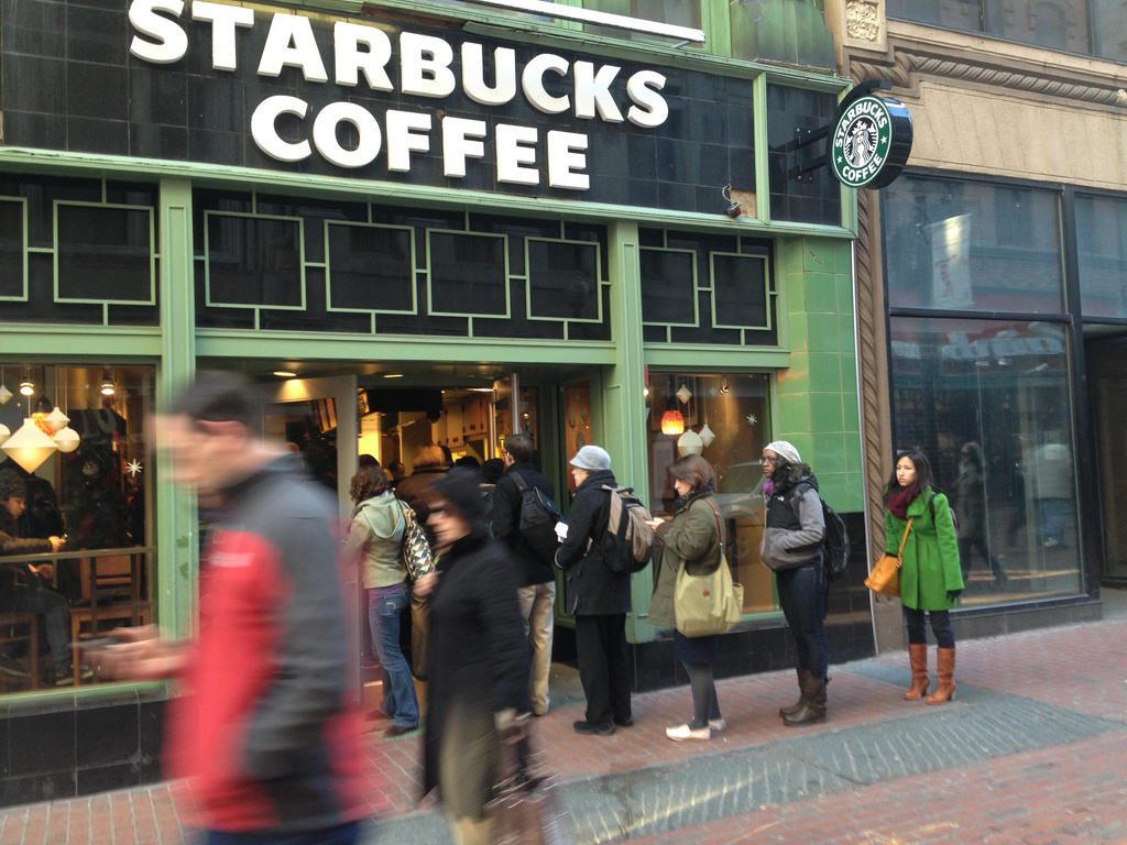 Customers line up at Starbucks all the way outside